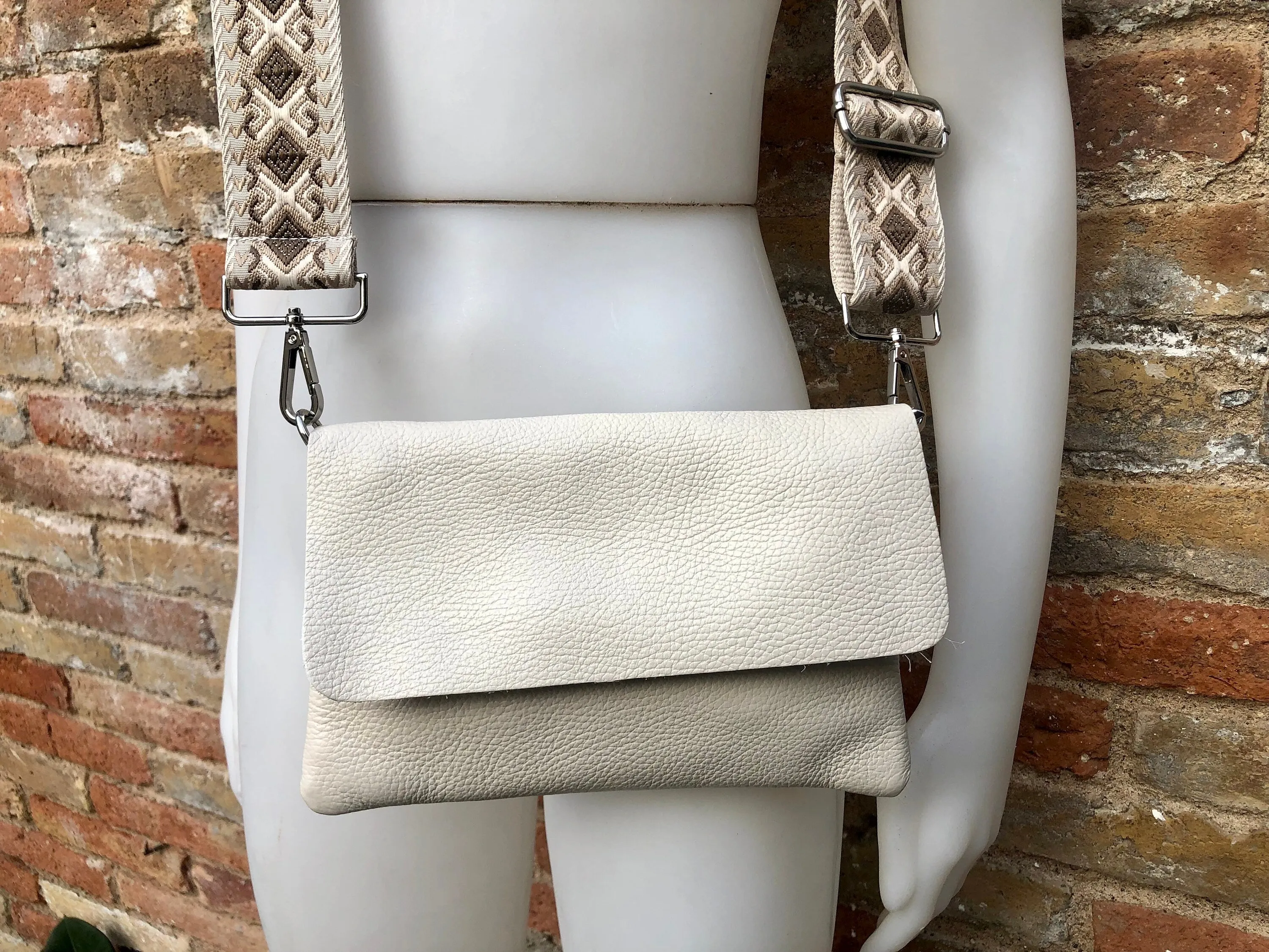 Cream color small leather bag. 2 straps: 1 leather   1 guitar strap. GENUINE leather Crossbody / shoulder bag. Light beige purse with flap