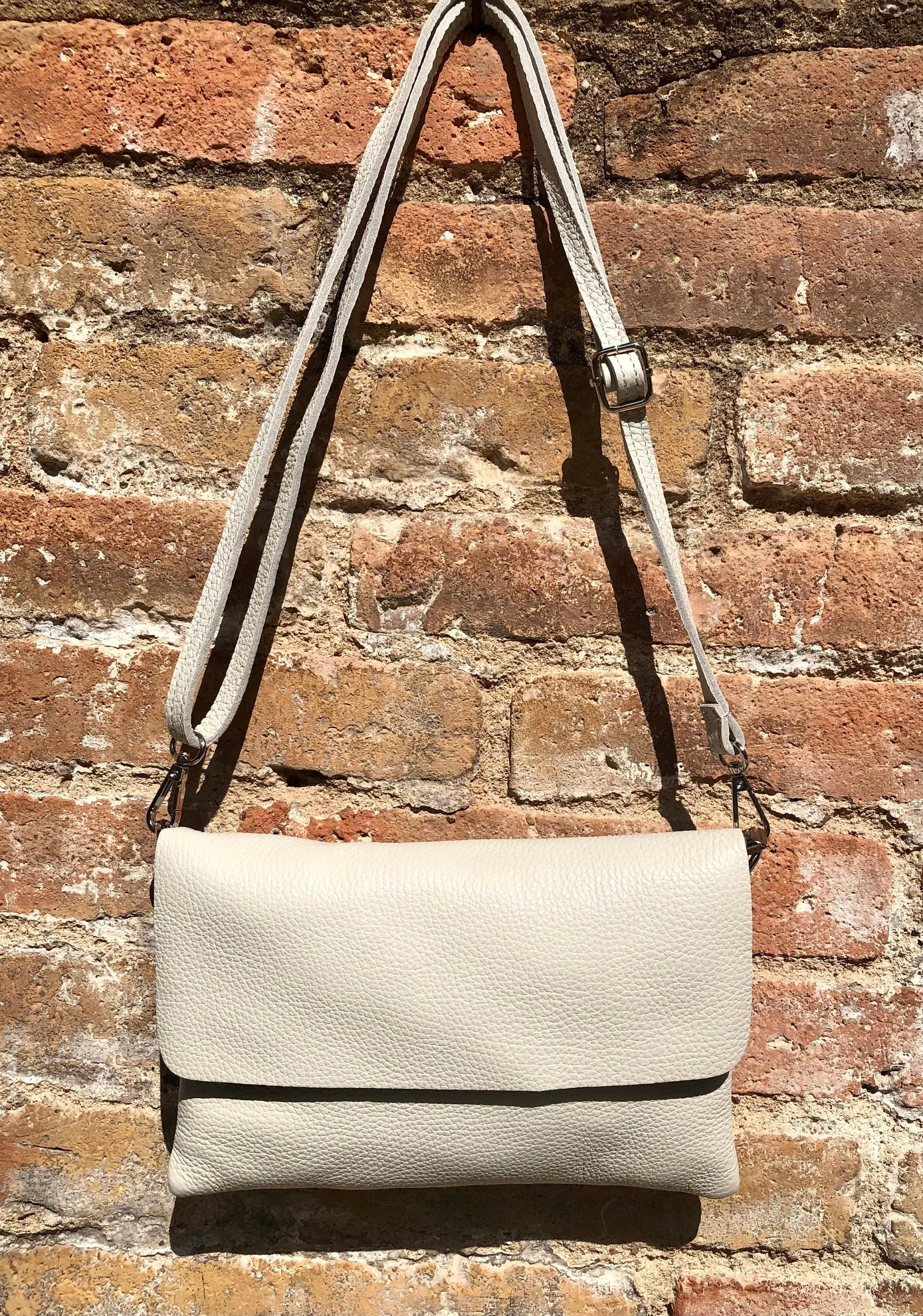 Cream color small leather bag. 2 straps: 1 leather   1 guitar strap. GENUINE leather Crossbody / shoulder bag. Light beige purse with flap